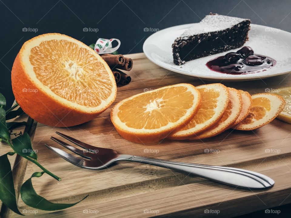 Dessert with orange fruit and cinnamon on chopping board