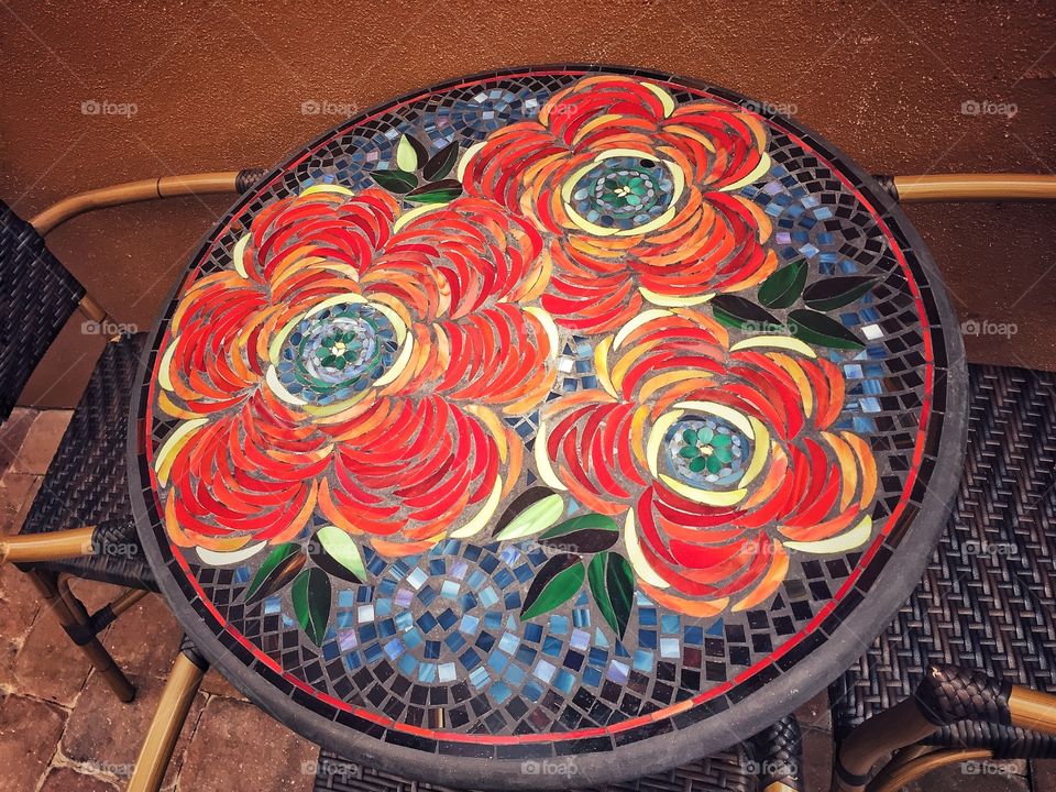Beautiful bright colored mosaic table with flowers 