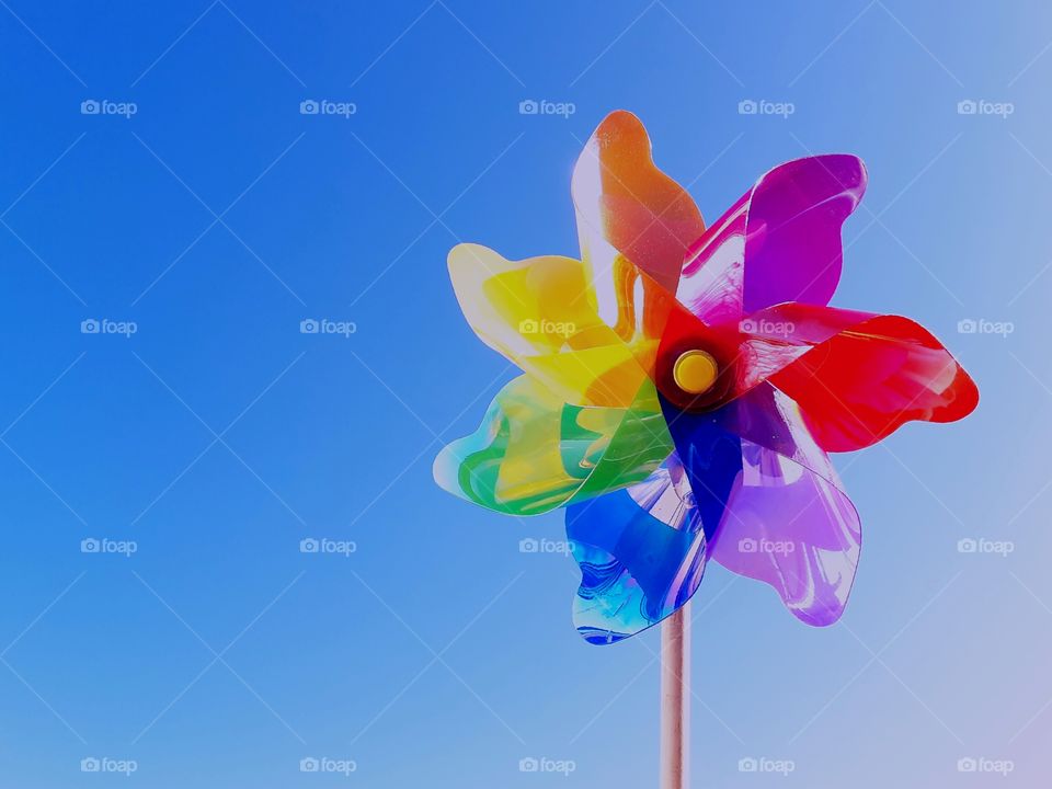 colorful little pinwheel in front of blue sky