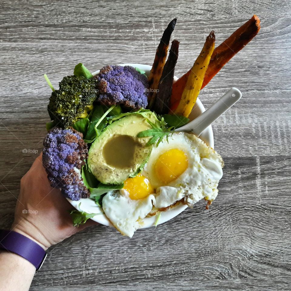 Hand holding breakfast in bowl