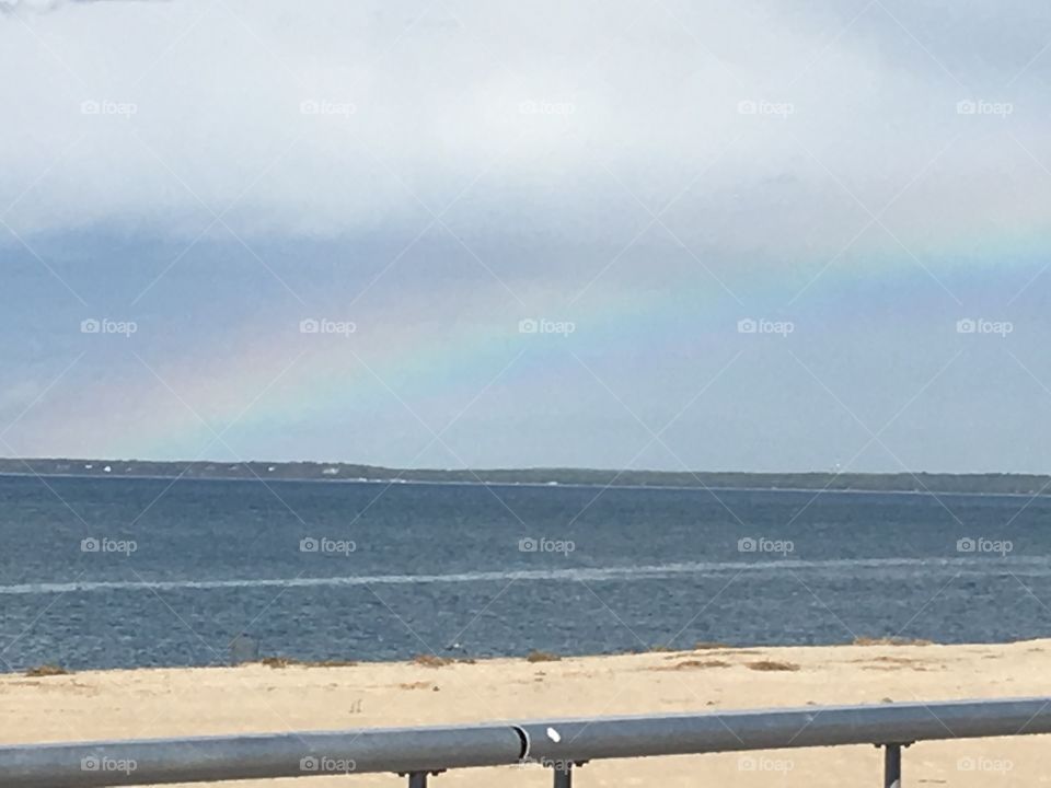 A Rainbow at the beach after a rain storm.