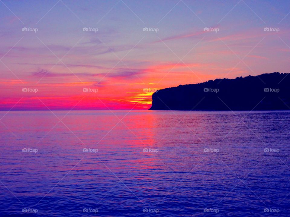 Sunset over Islet of Dino ( Italy ).