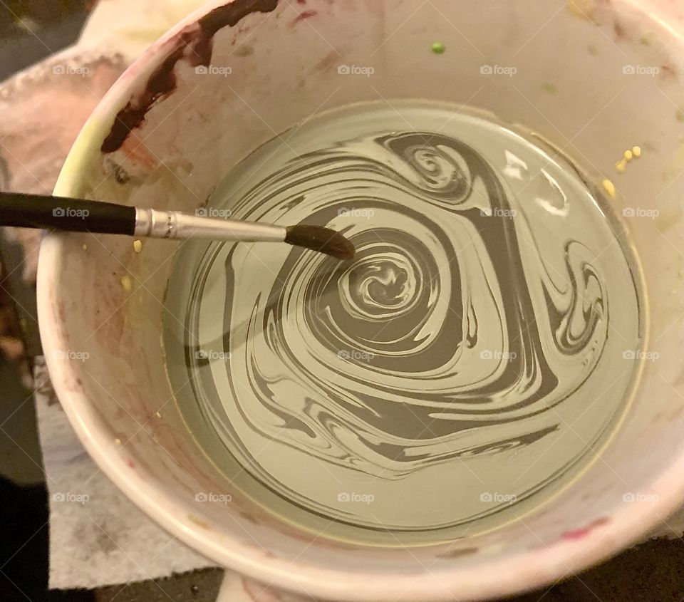 Mixing paint with a paintbrush 