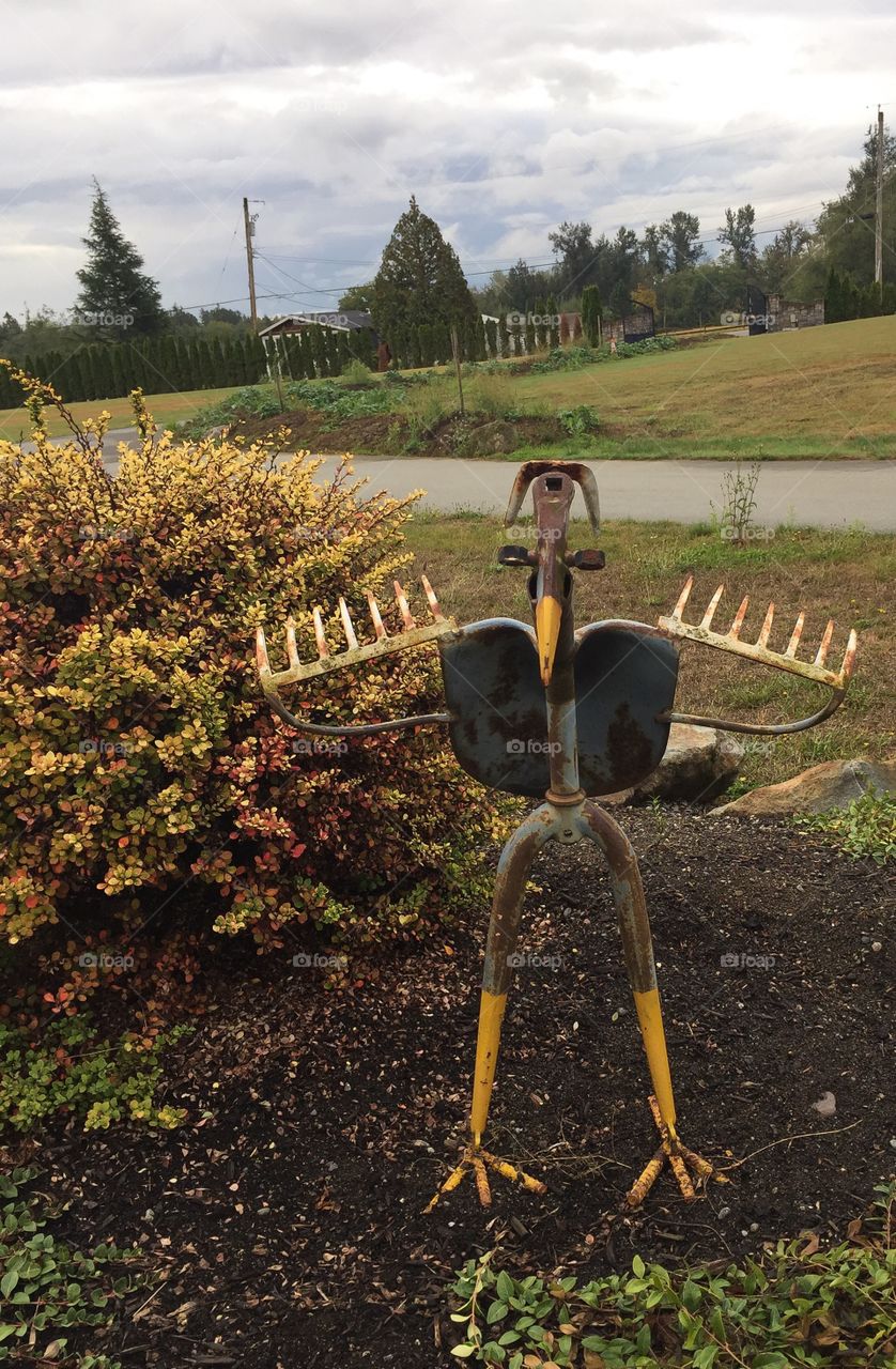Metal bird ornament made out of old garden tools in British Columbia 