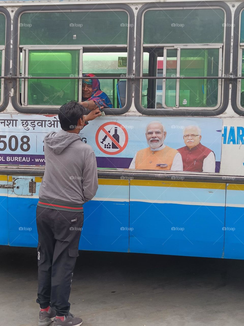 A man leaving his mother at the bus station.