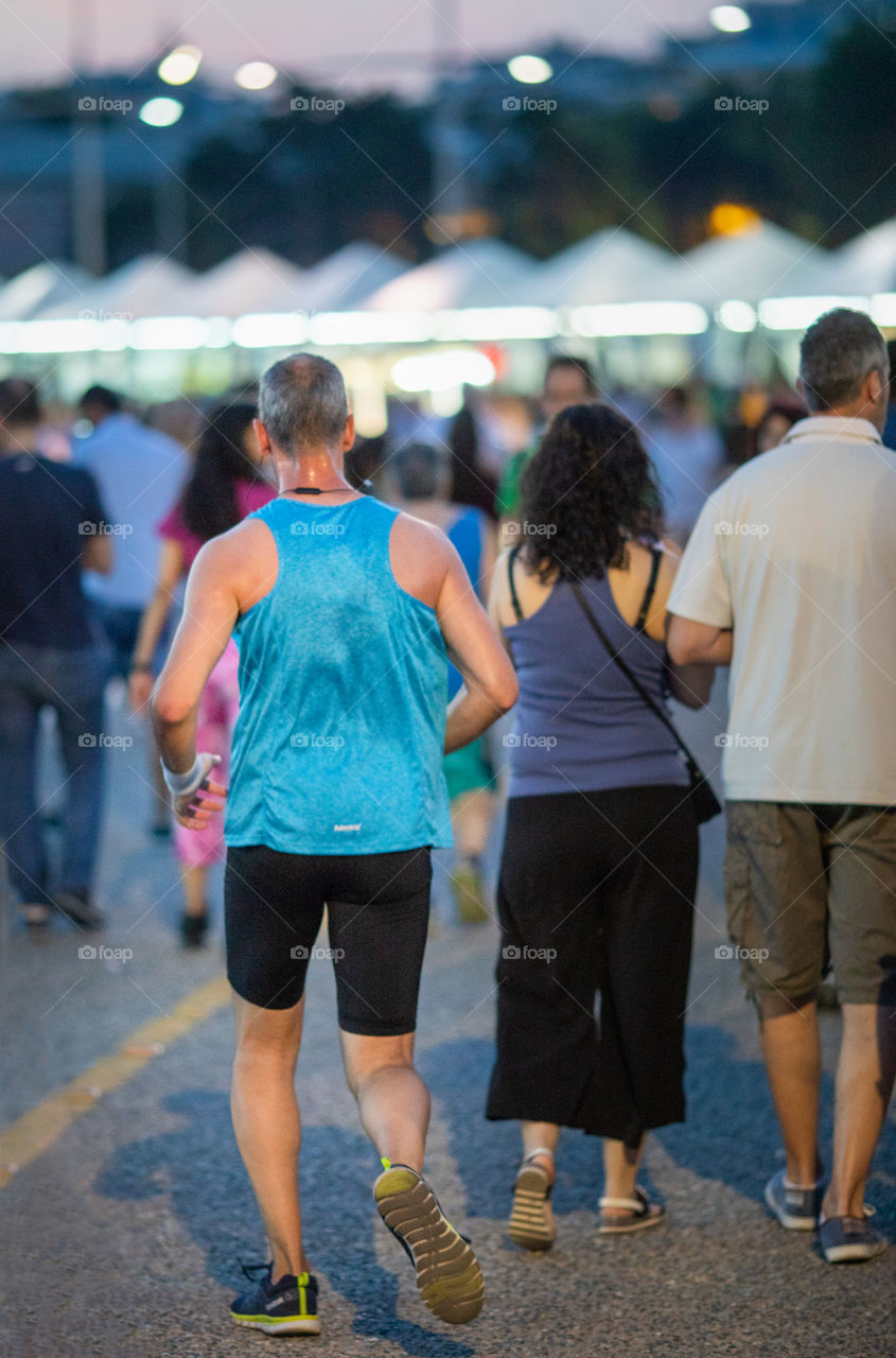 Man Running in crowd of people