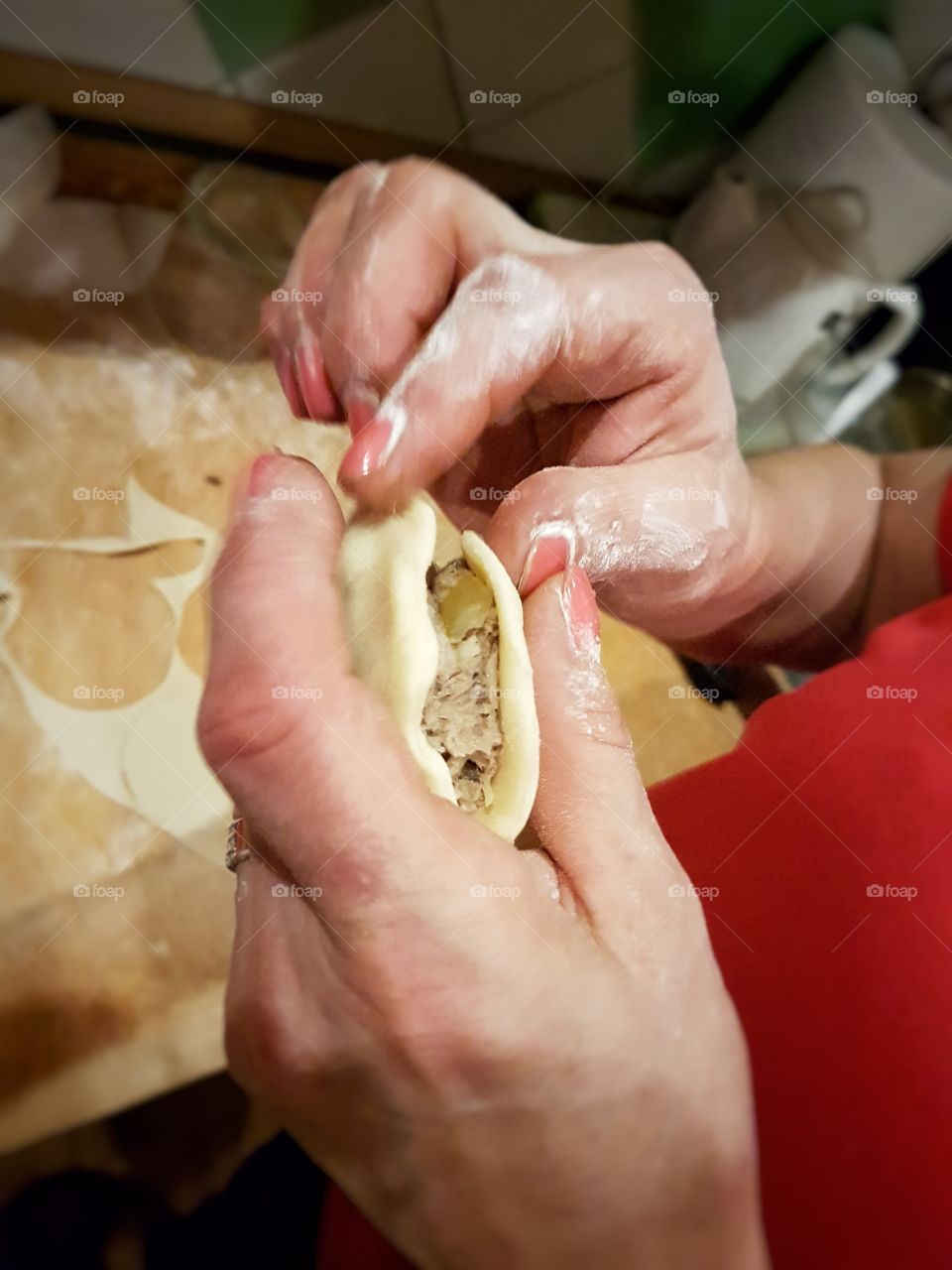 Close-up of person making piegori