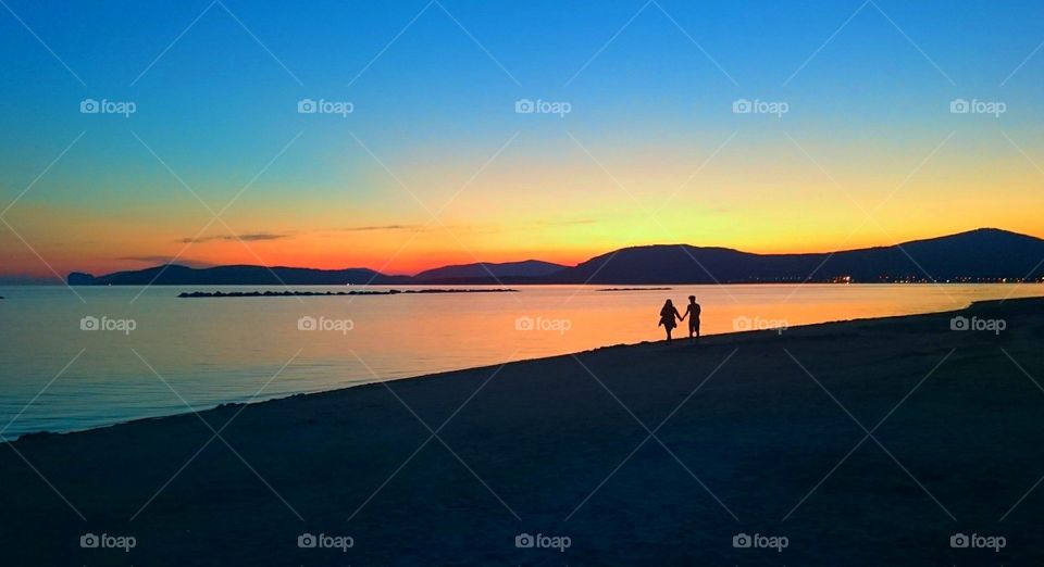 walking hand in hand in the sunset . walking hand in hand in the sunset 