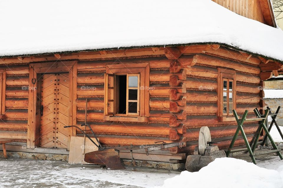 winter wooden mountain lodge covered in snow