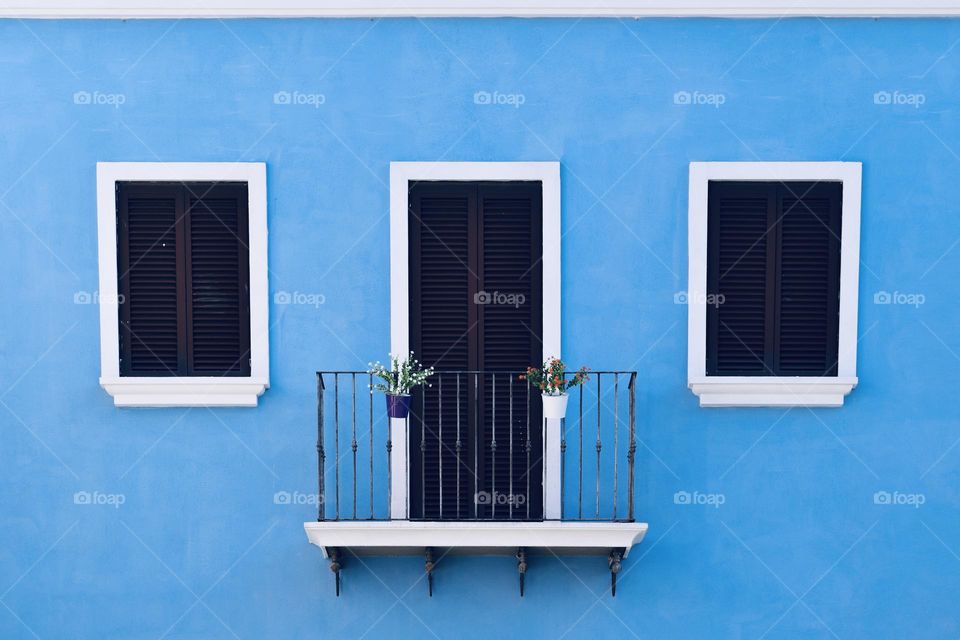  Balcony and two windows on a blue wall
