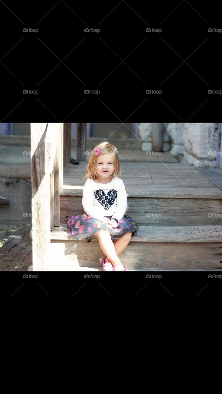 Little Girl Sitting on Steps