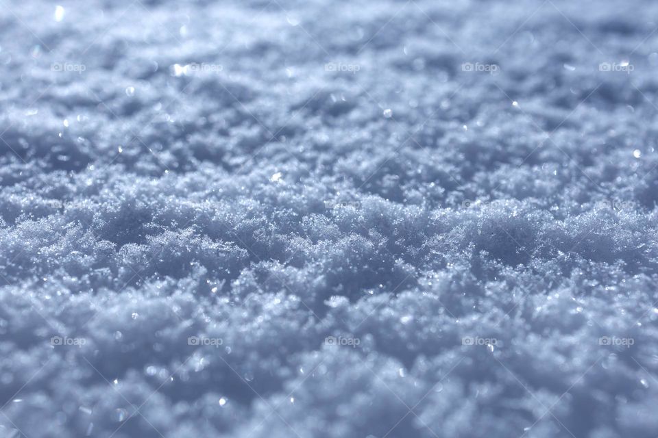 Selective focus snow background with flickering snowflakes. 