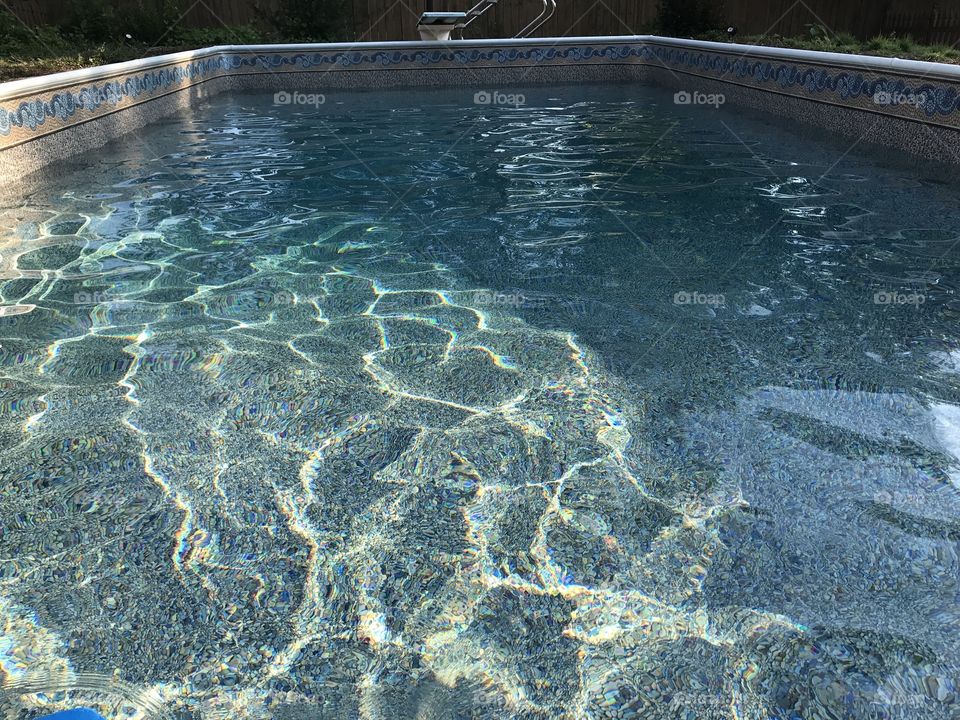 Sparkling pool water against ricks oebbles
