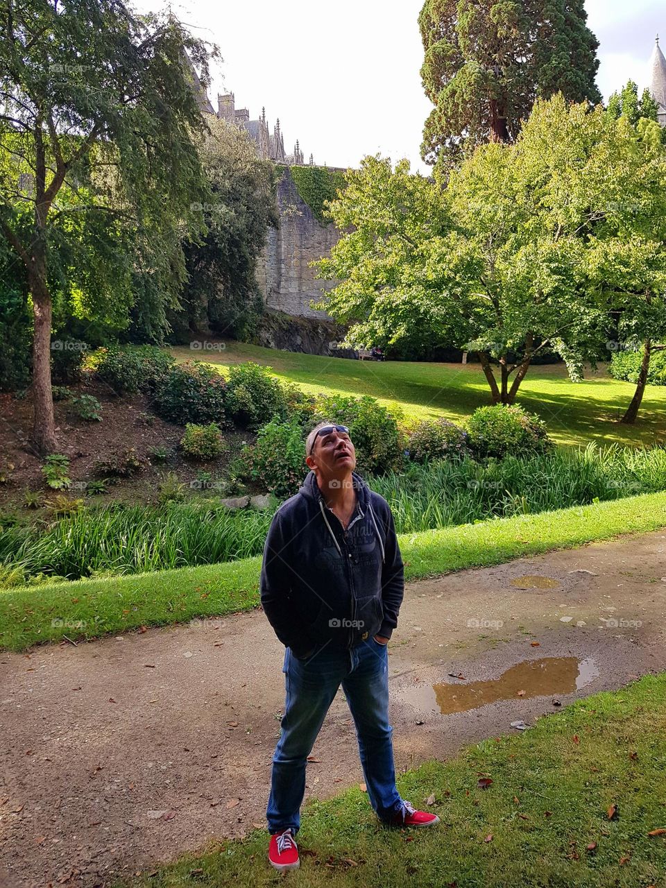 A father looking up at the sky in the gardens of Josselin Castle