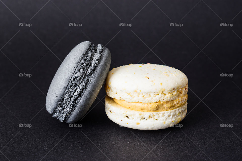 Black and white macaroons in dark background 