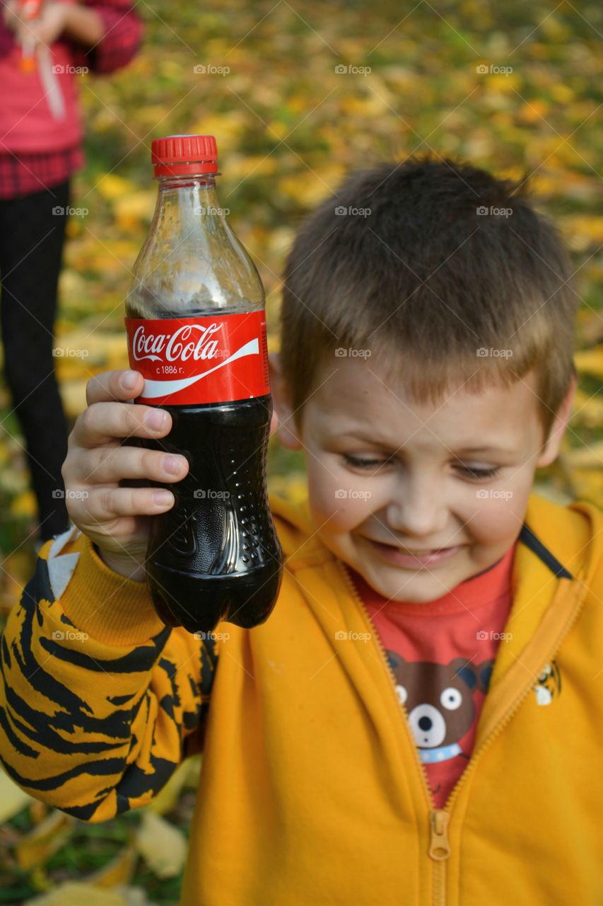 coca cola in the hands child outdoor