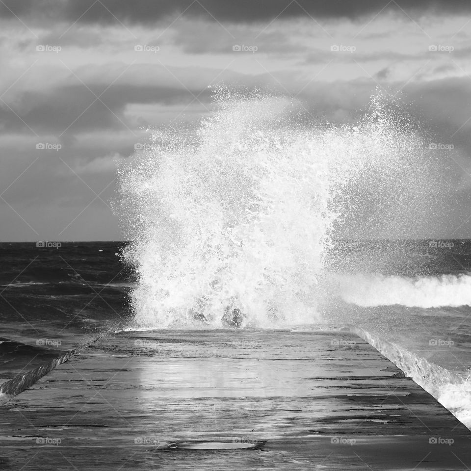Waves splashing up on jetty