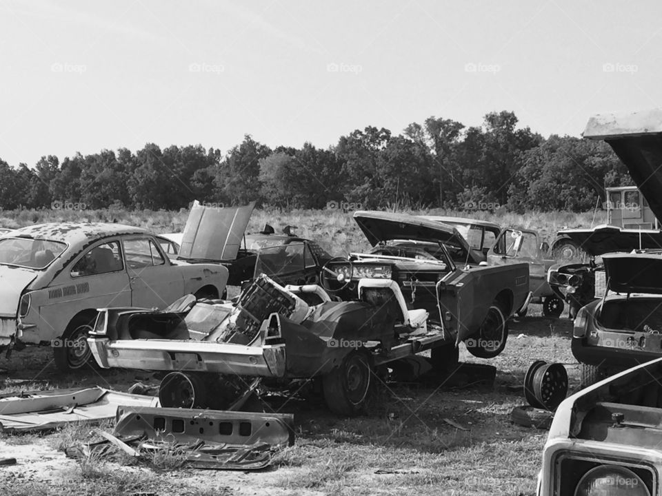 Rusting away. Old car in a junk yard. 