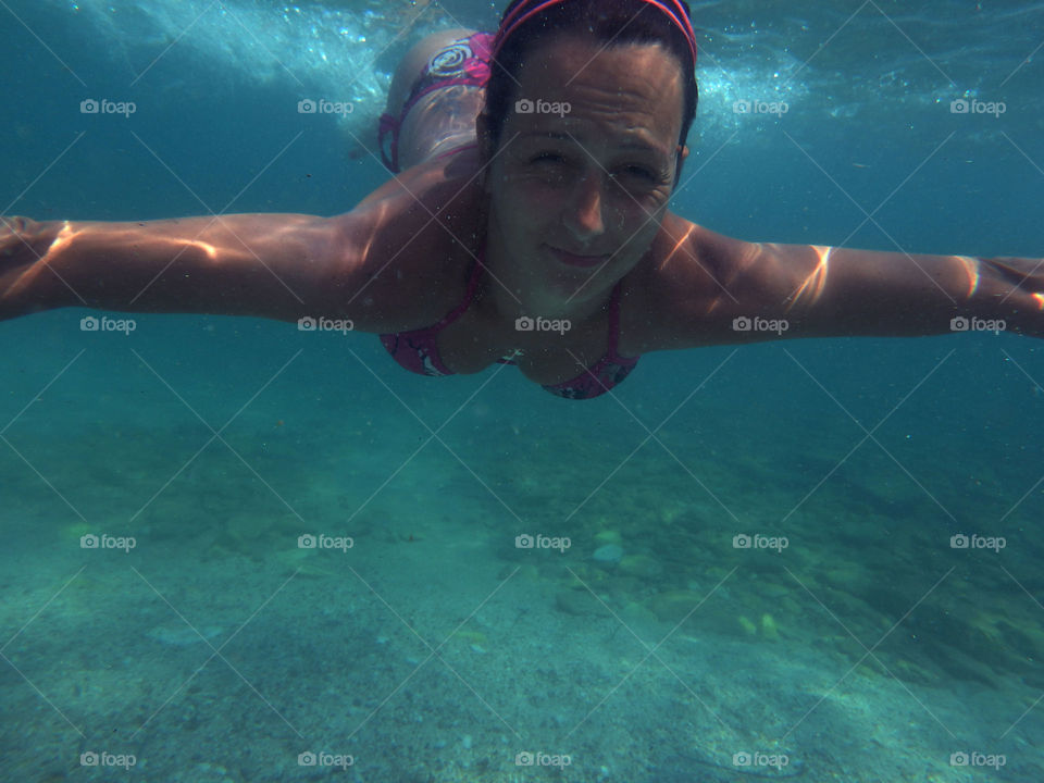 woman underwater. woman swimming underwater below the surface