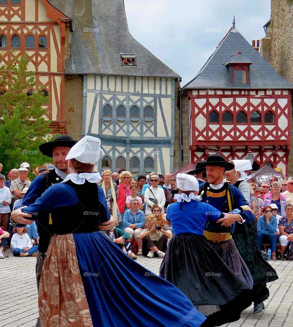 Couples dressed in Breton traditional costumes at St Loup festival in Guingamp