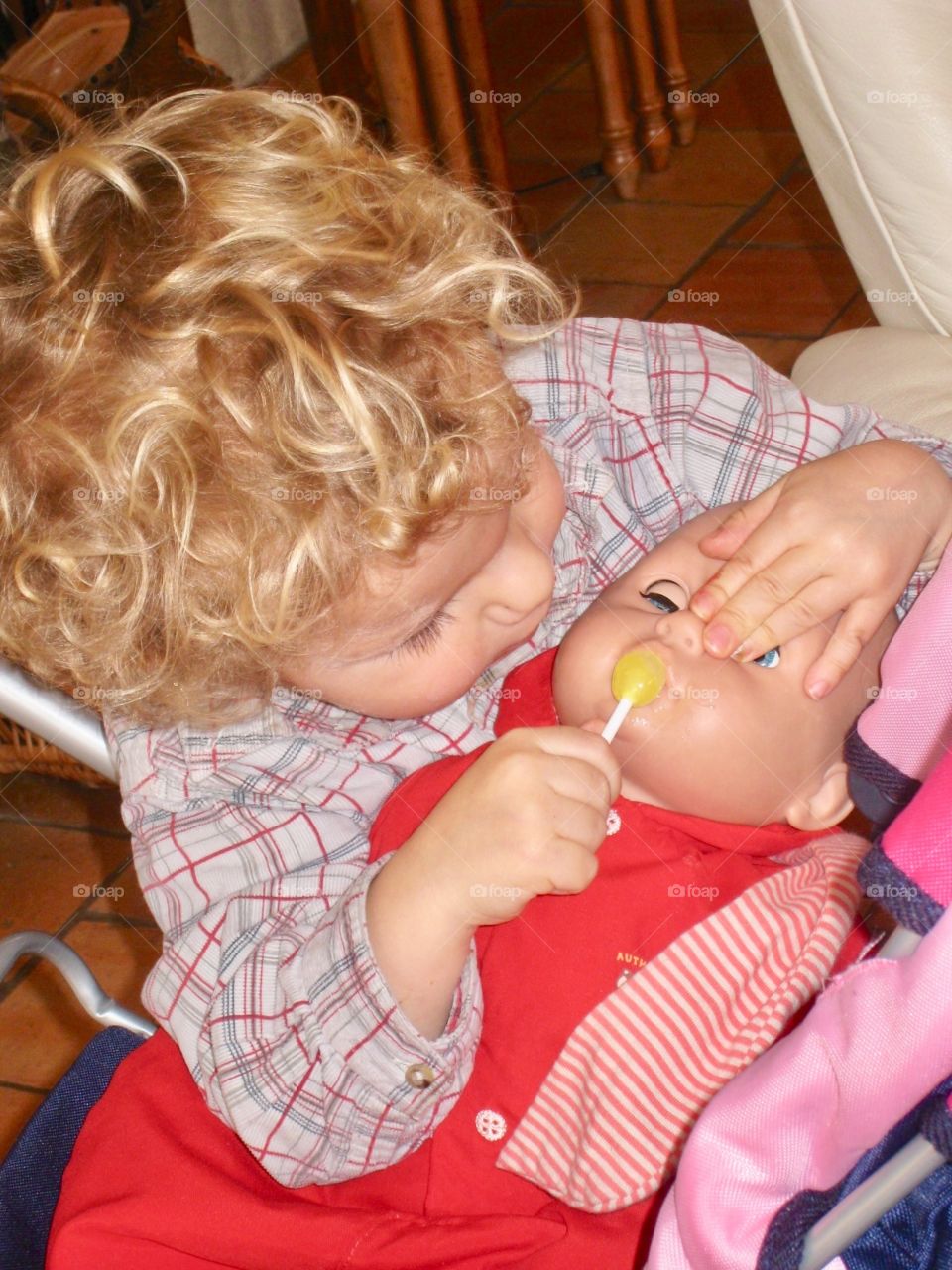 Child playing with a baby doll