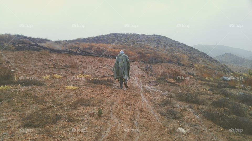 Slogging along on a muddy and rainy day.