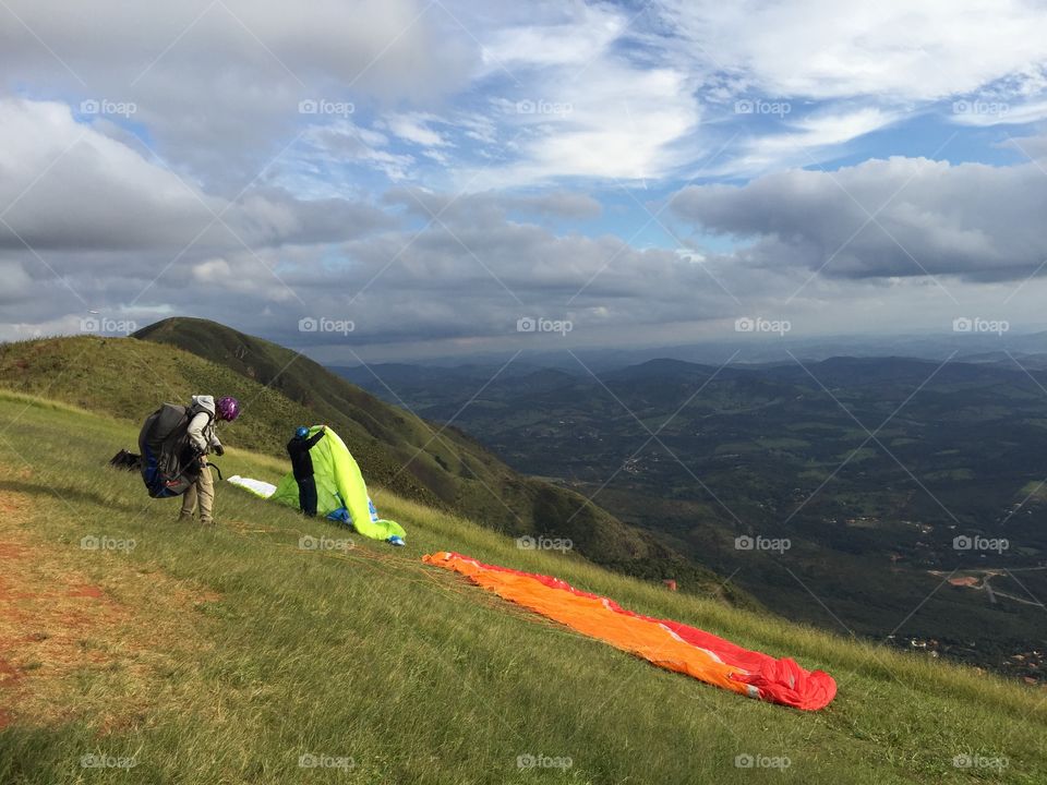 Preparing to fly . A guy prepares to fly in the mountain known as "the top of the world" in Minas Gerais state of Brazil. 