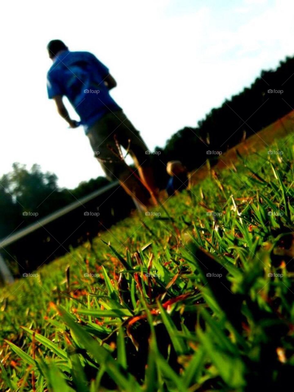 Daddy and son playing in the grass