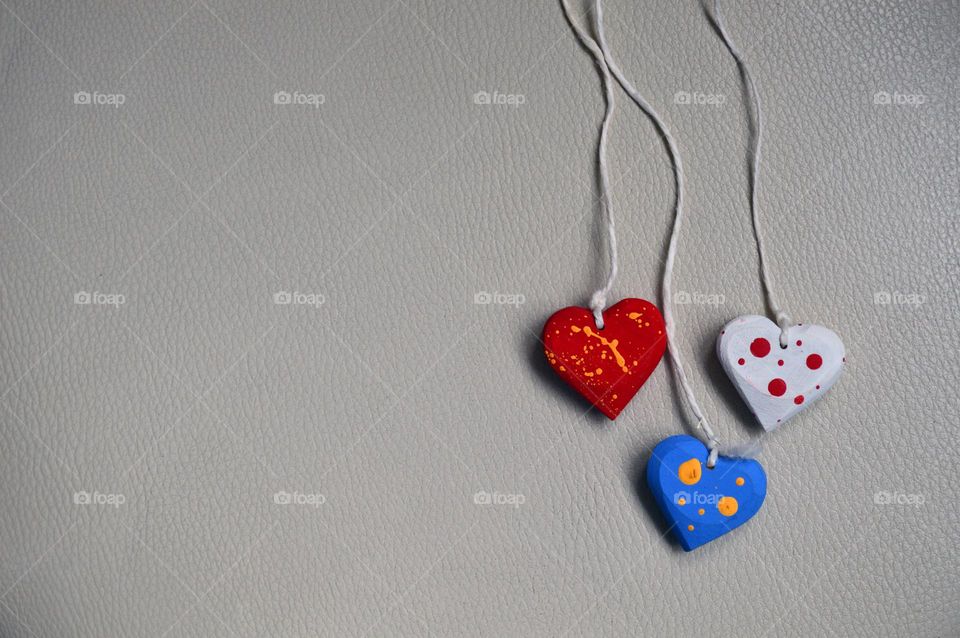 Multicolored wooden hearts on a thread