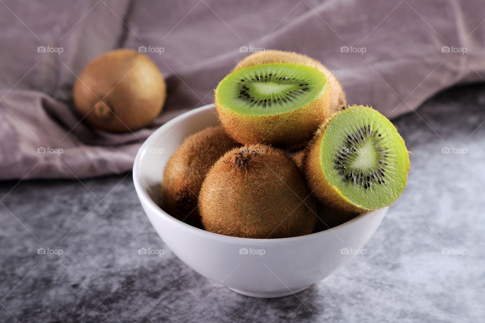 Fresh organic food fruit kiwi in a white bowl