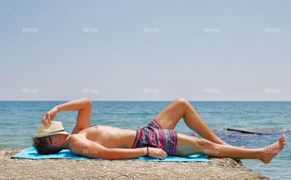 Relaxing boy on the beach