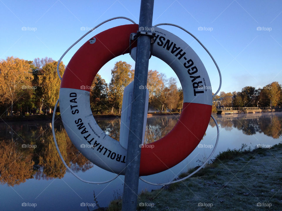 autumn safety safe river lake red white devided diversion lifesaver ring circular hope save insurance security secure by zebra