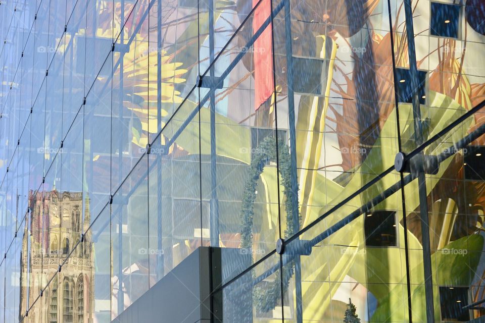 A reflection of a very old church in a very new building. 