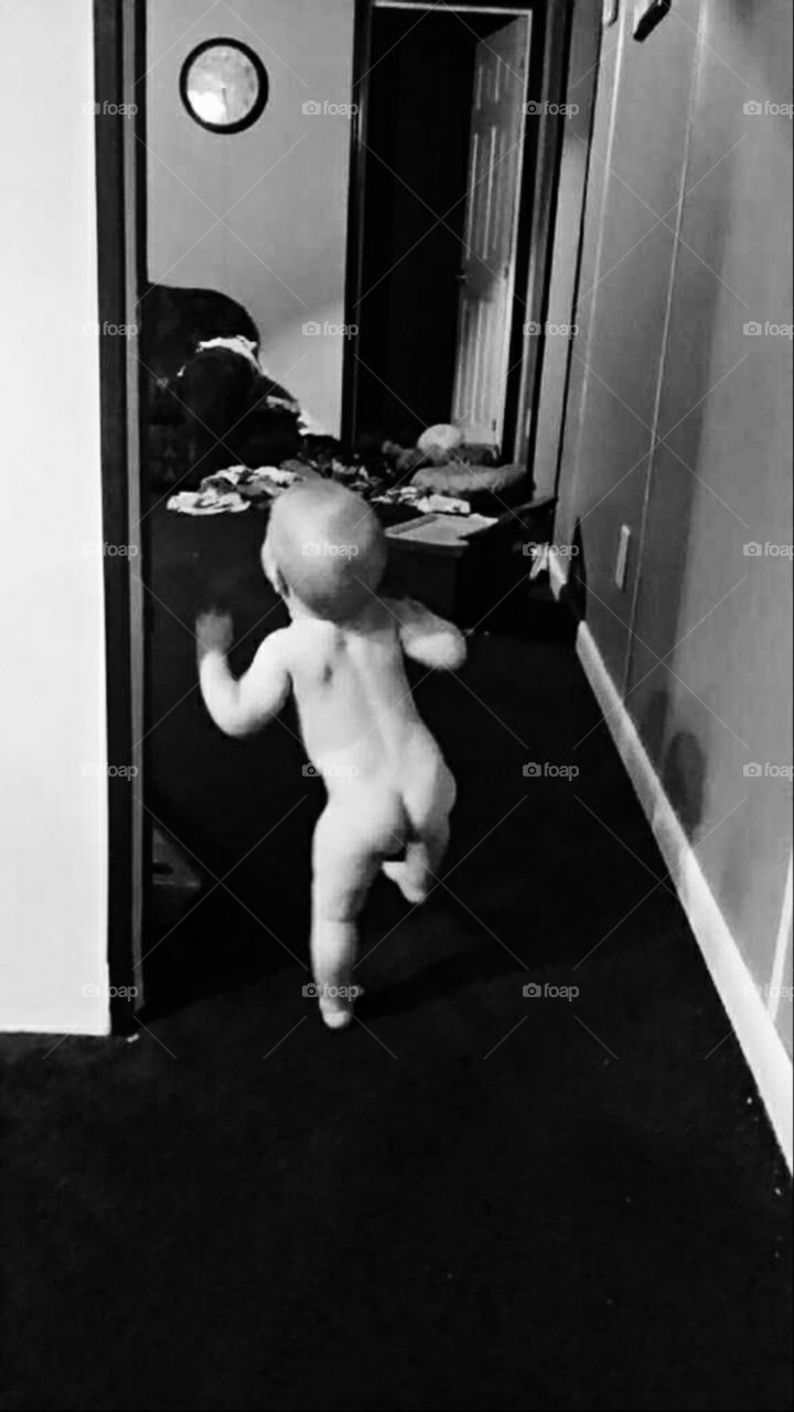 Naked baby butt running through his home. Average house with a real mess in the background. This could represent the real American family.