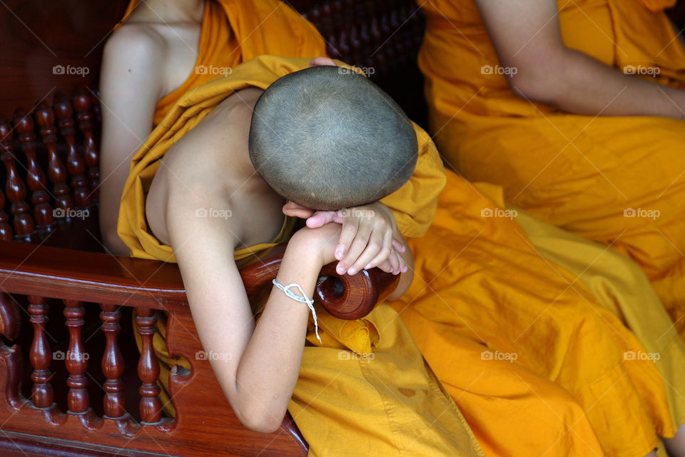 monk sleep. young monk sleeping on chair