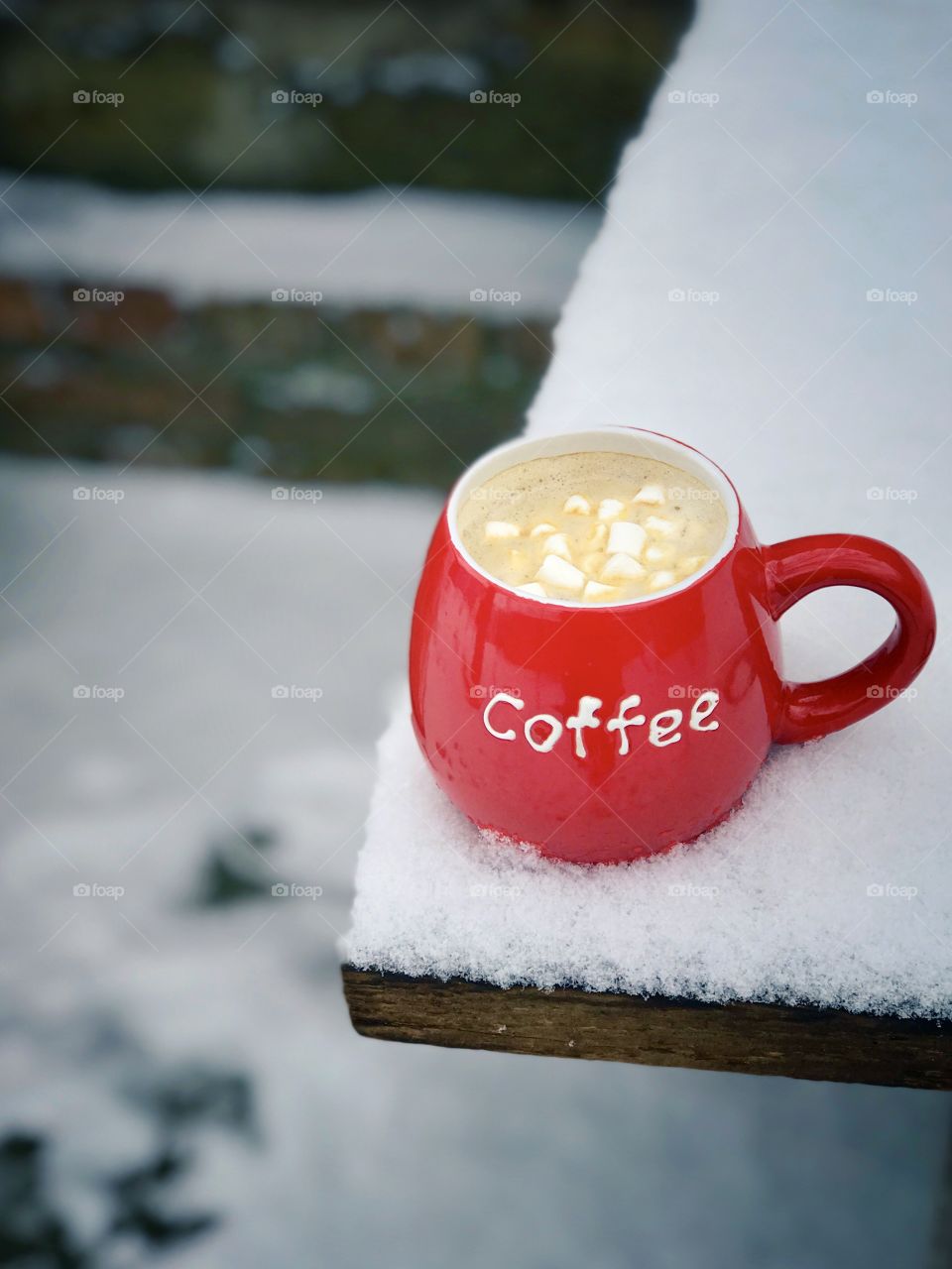 Black coffee and marshmallows in red mug 