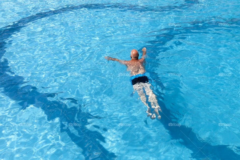 Man swimming in the pool, healthy lifestyle