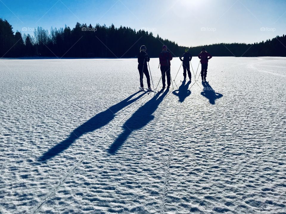 Skiing with friends on a frozen lake 
