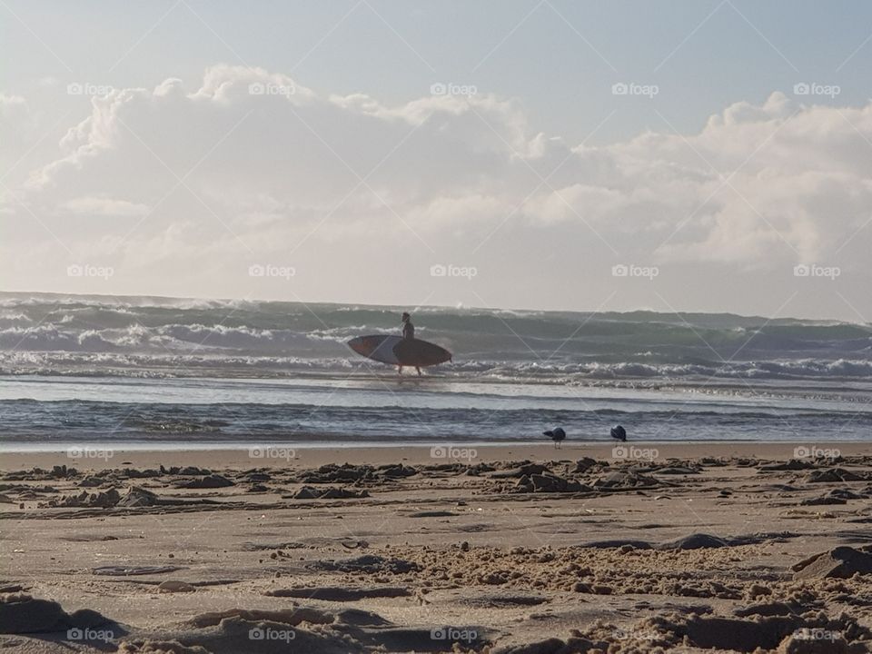 early surfer catches the waves