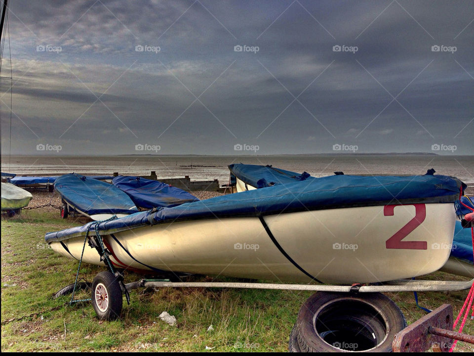 Sailboat on trailer by sea