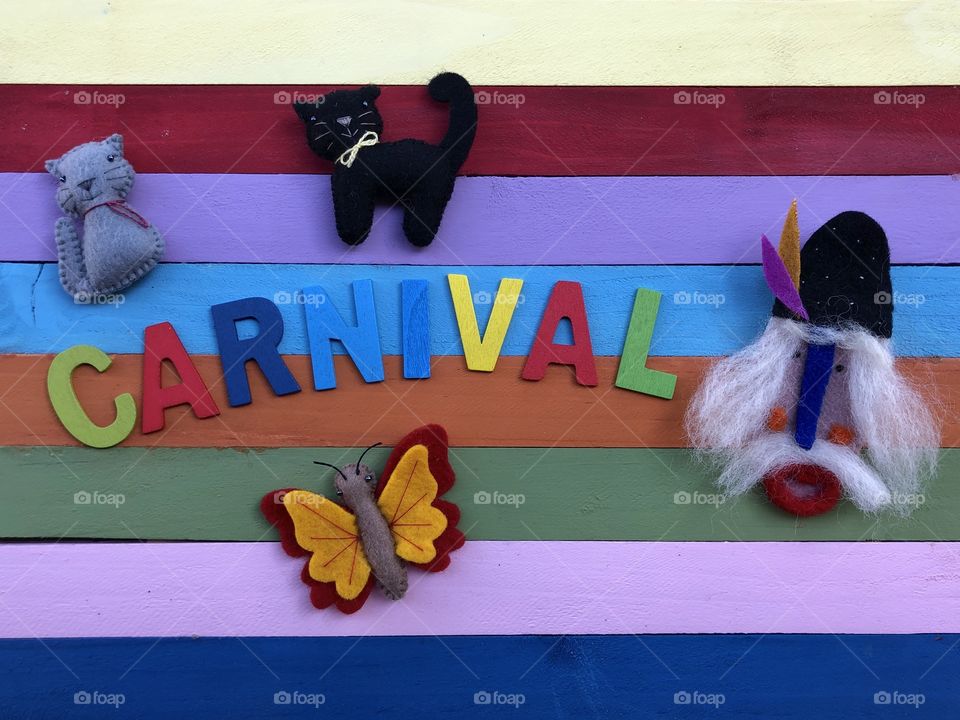 Carnival text with multicolored wooden letters and board with creative decorations