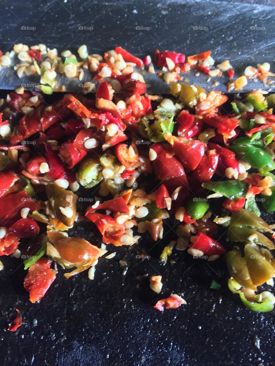 A chopped bird’s eye chili pepper for the preparation of making a chili garlic oil for dumplings.