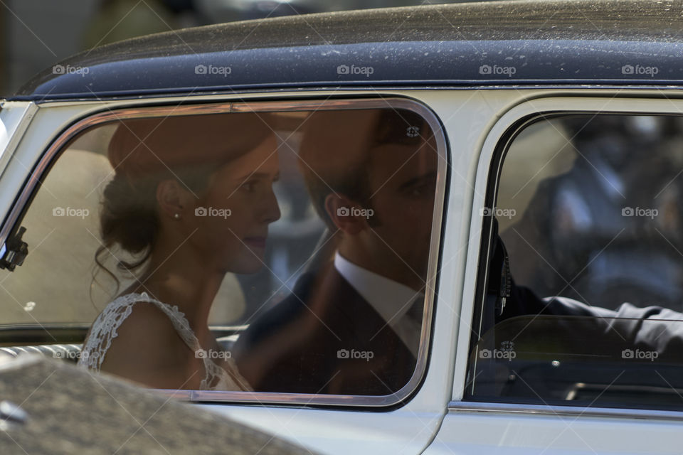 Bride in a small vintage car