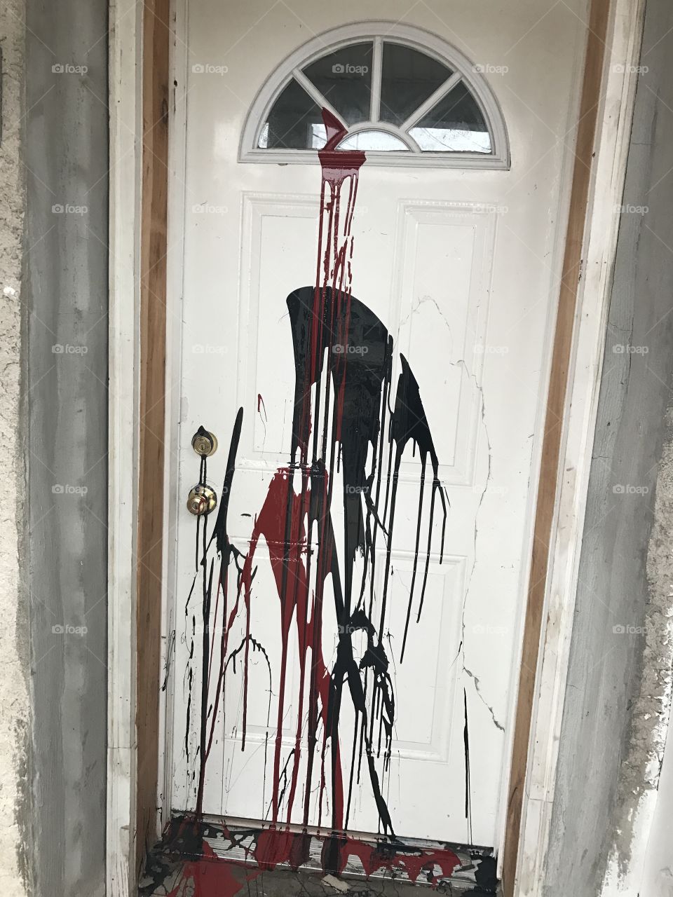 Vandalism black and red paint on the door