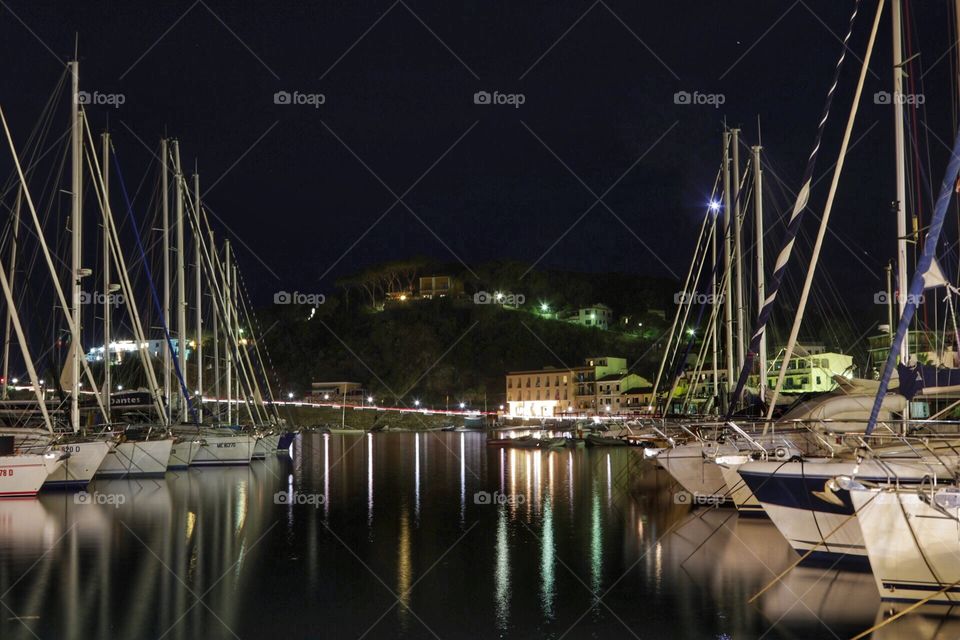 Sailing boats in a port in the night 