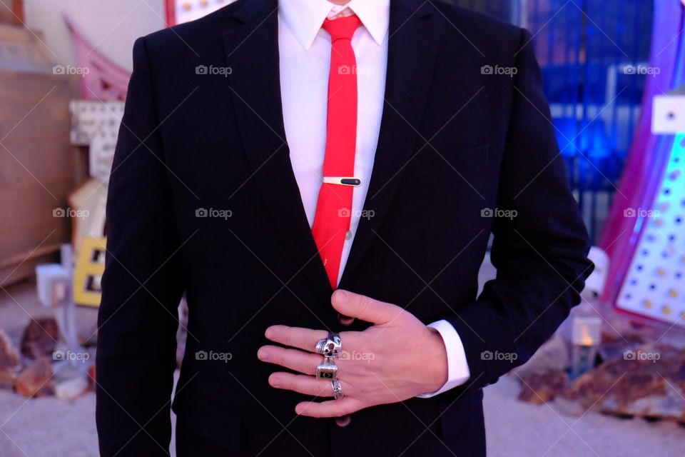 Groom getting ready for wedding, red tie dressed up in a suit, wedding photography 