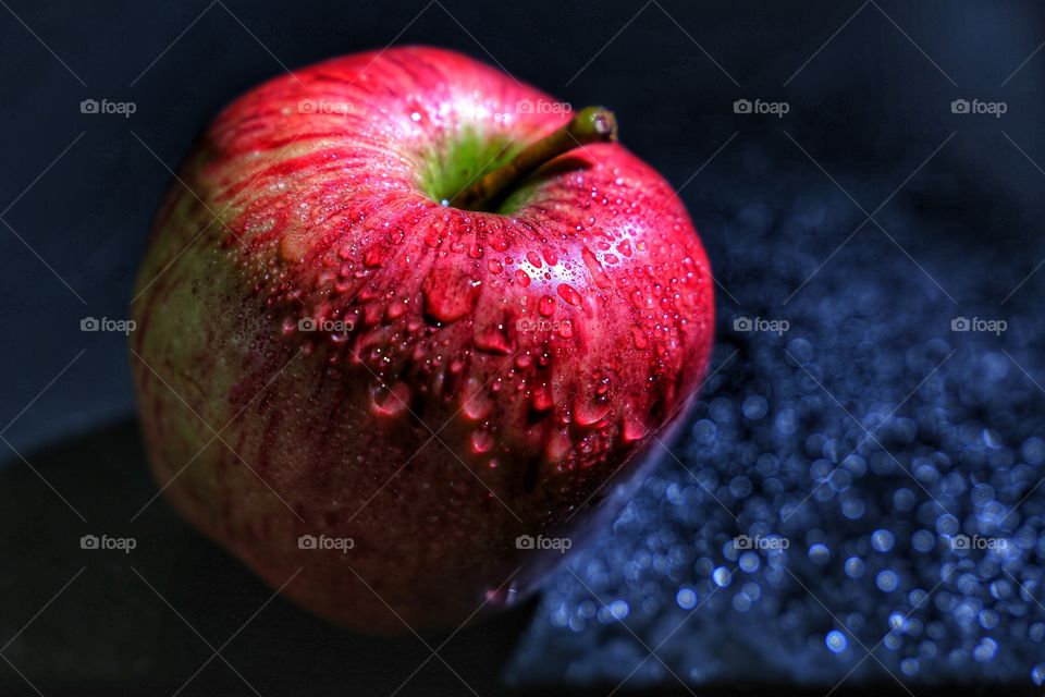 Red apple with water drops