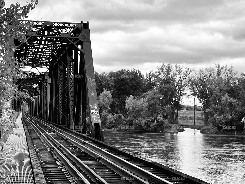 Black and white train bridge over water 