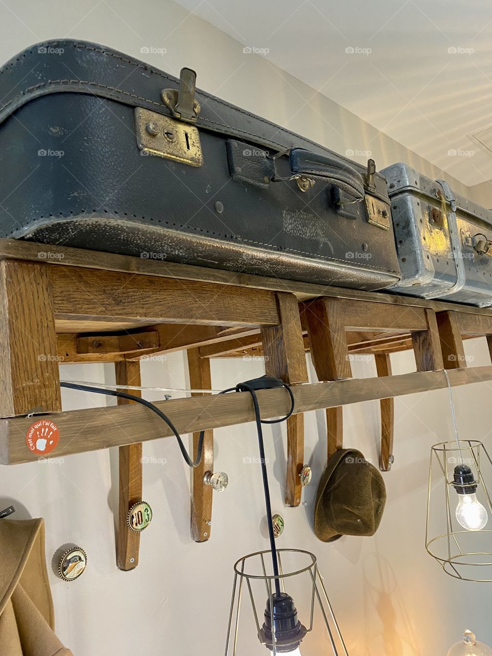 Suitcases placed on a wooden shelf in a vintage interior