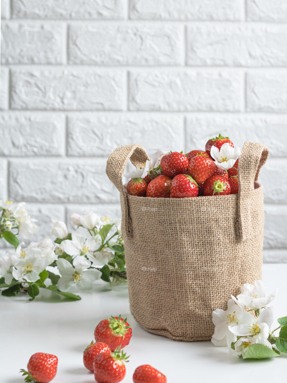 jute bag full of ripe fresh strawberries 